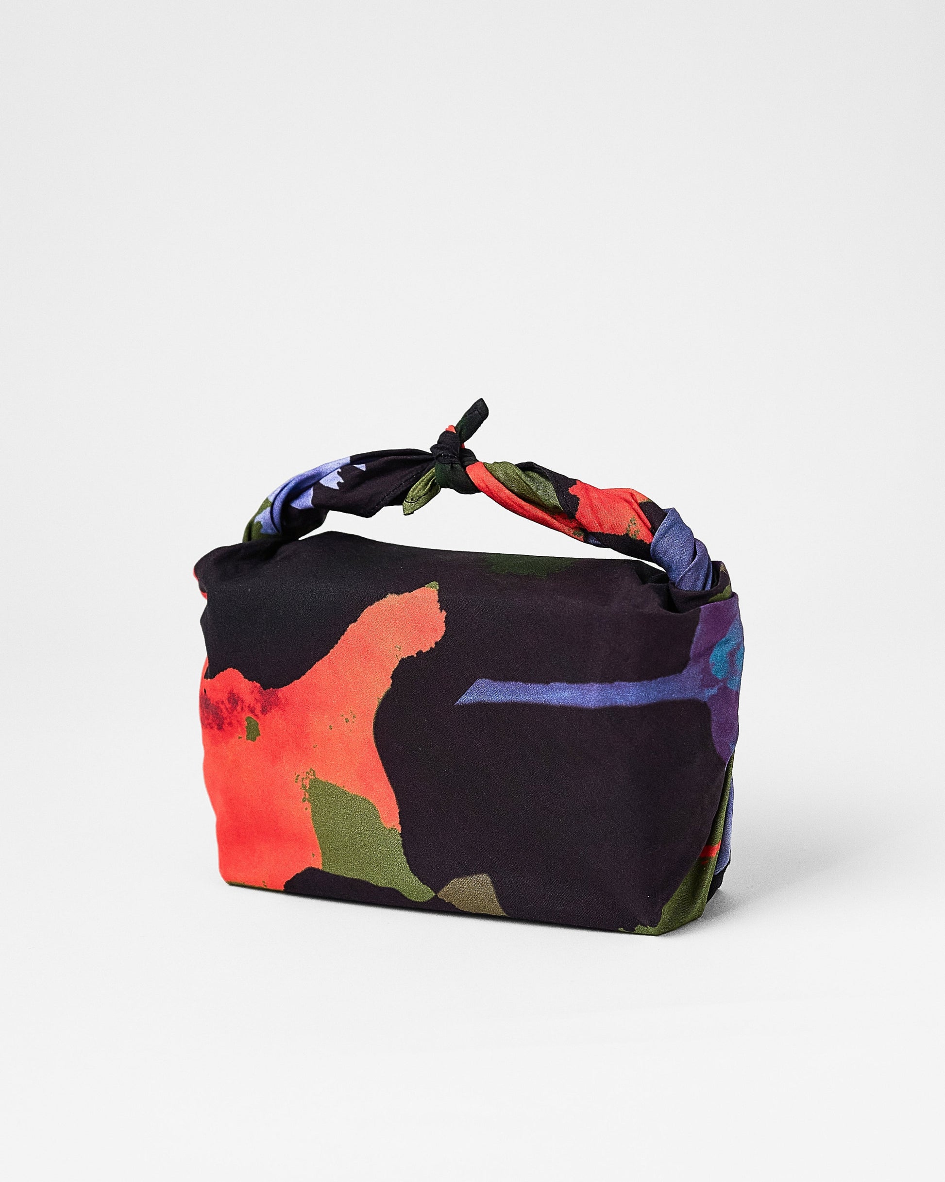 Colorful handbag with floral design on a white background
