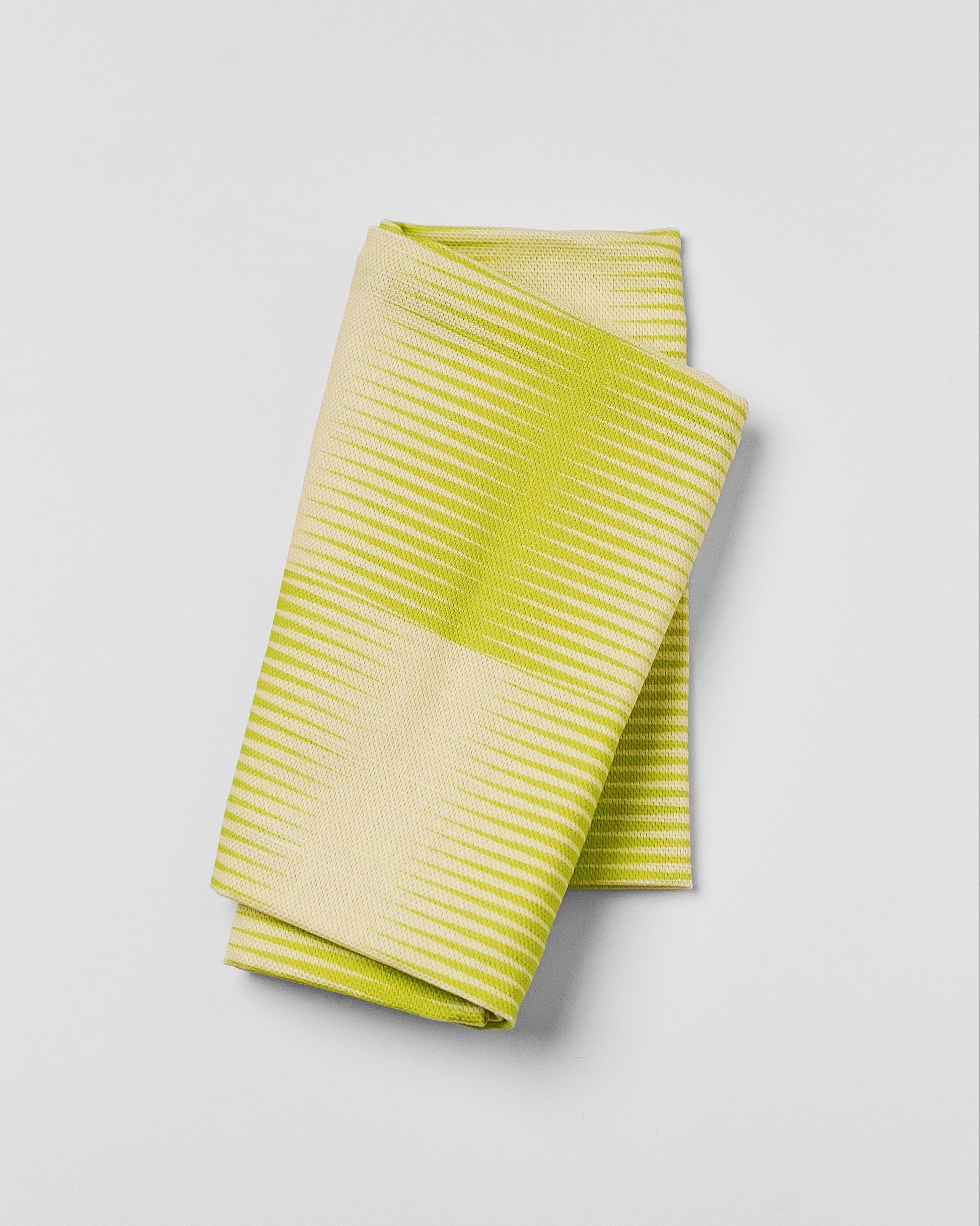 Green striped fabric on a light gray background