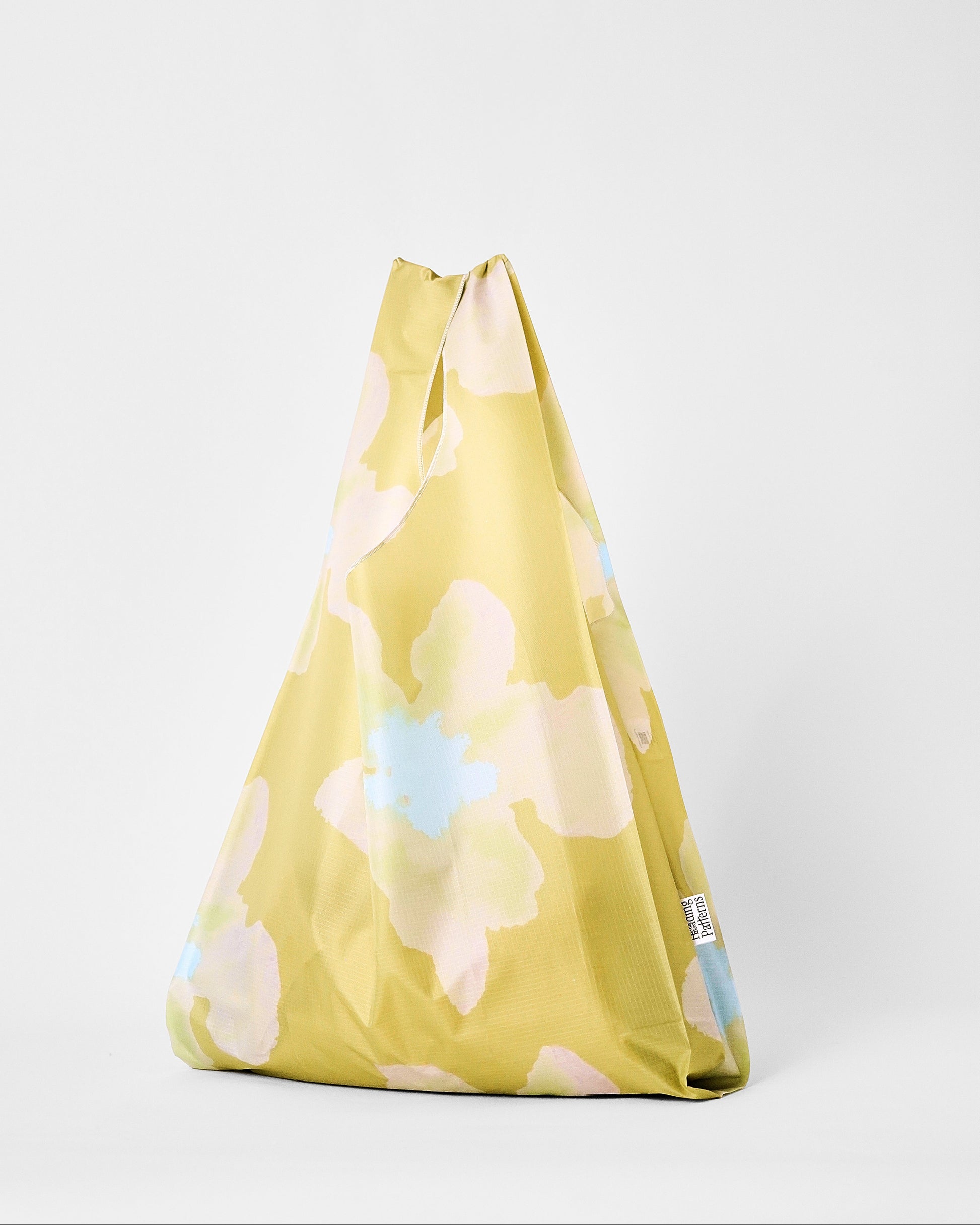 Yellow floral-patterned bag on a white background