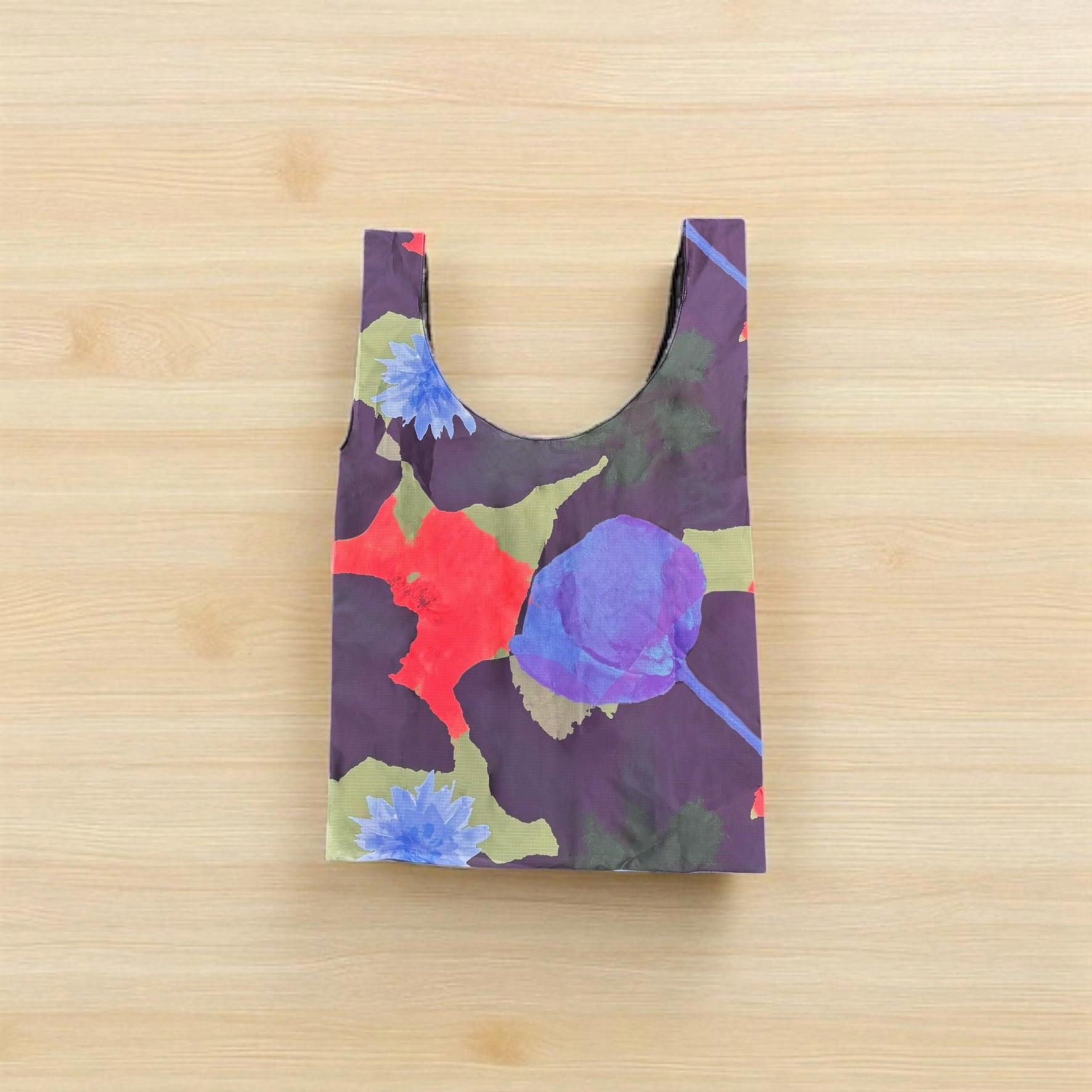 Floral patterned reusable bag on a wooden surface