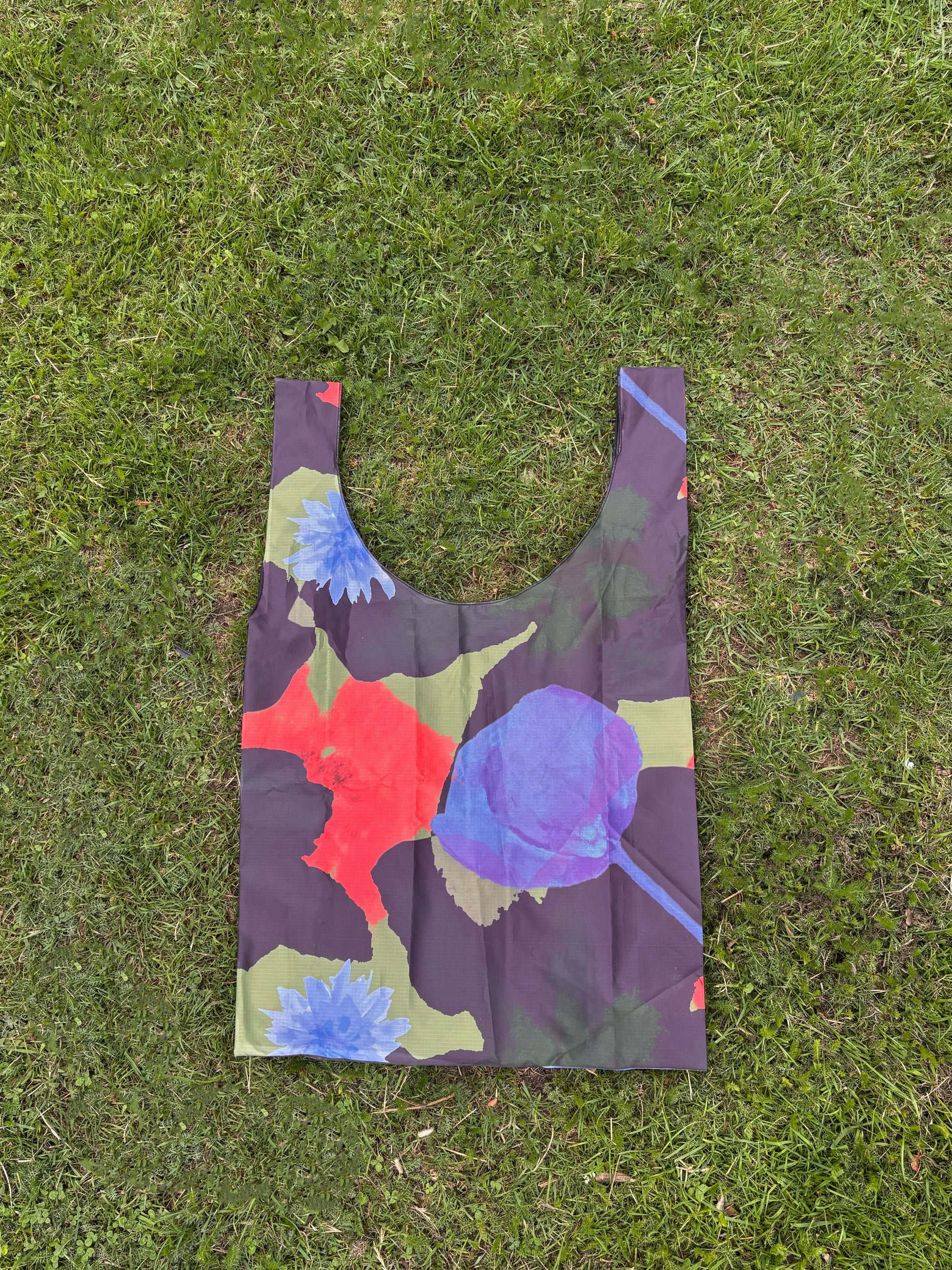 Floral-patterned reusable bag on grass