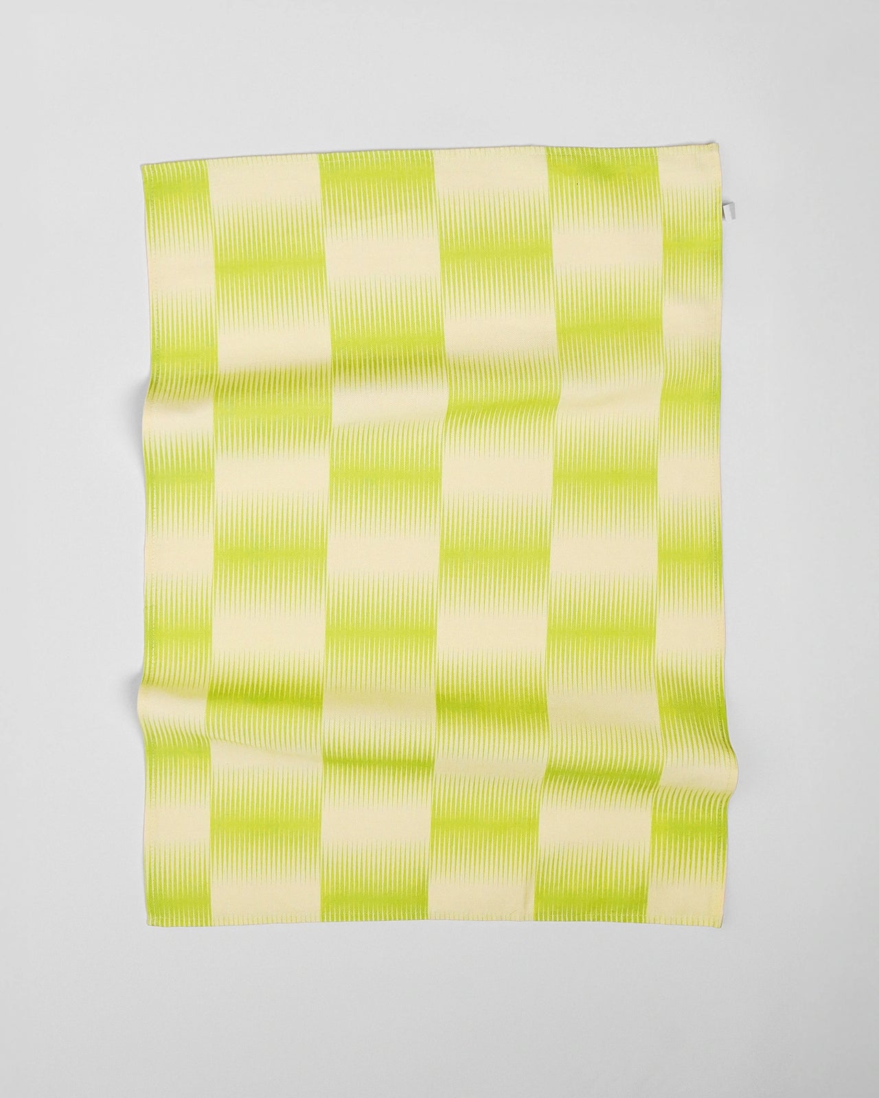 Green and white checkered towel on a light gray background