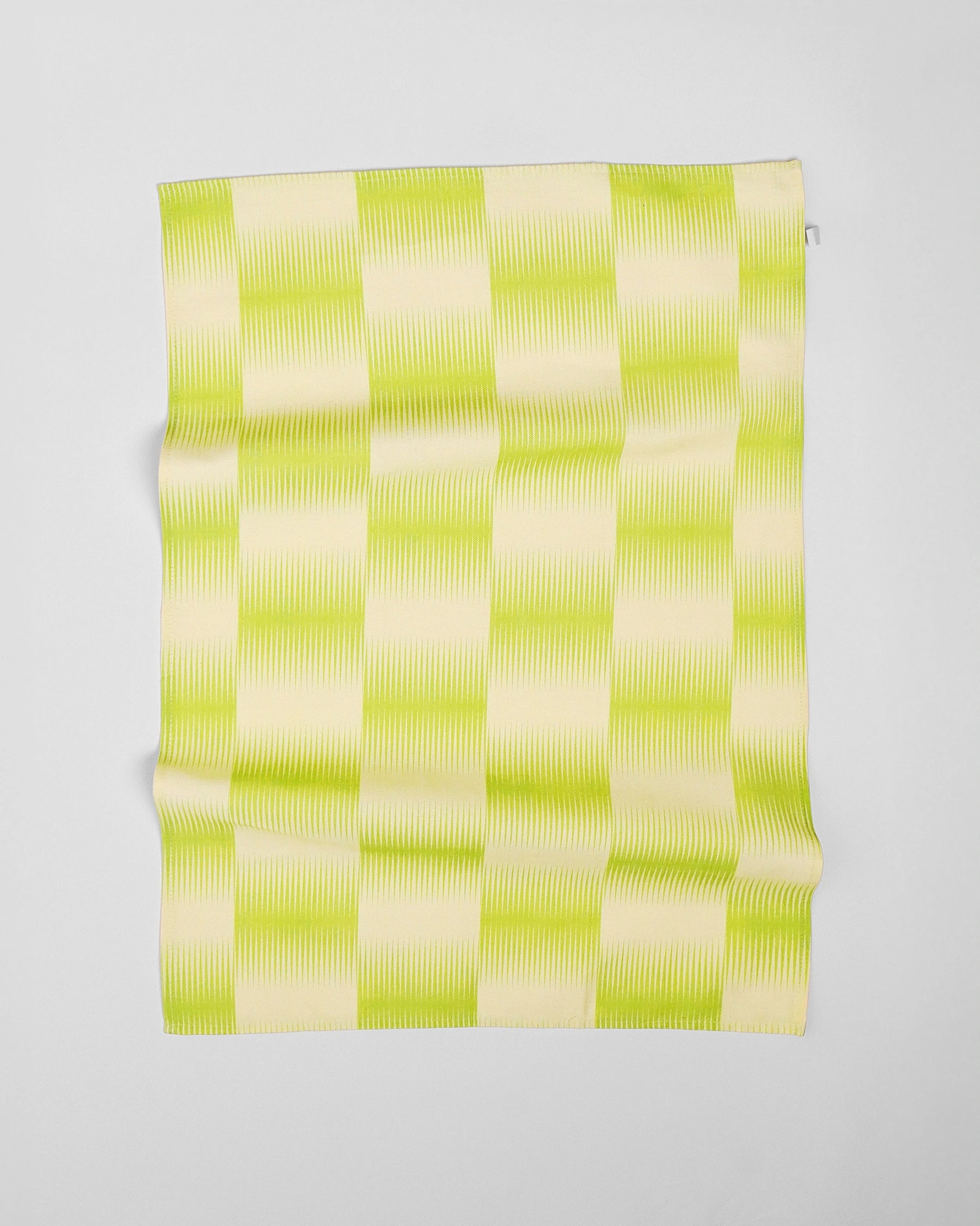 Green and white checkered towel on a light gray background