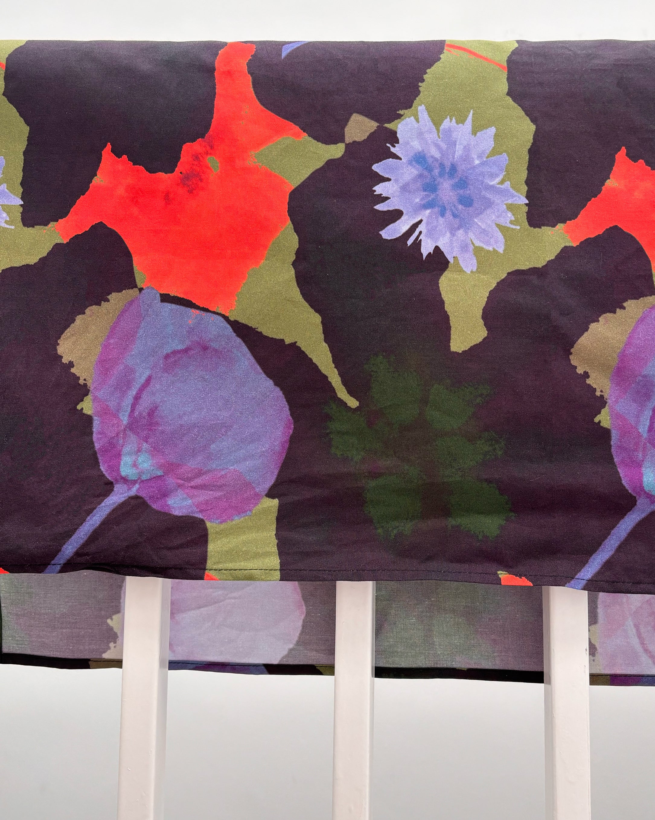 Floral patterned roman blind with colorful flowers on a dark background